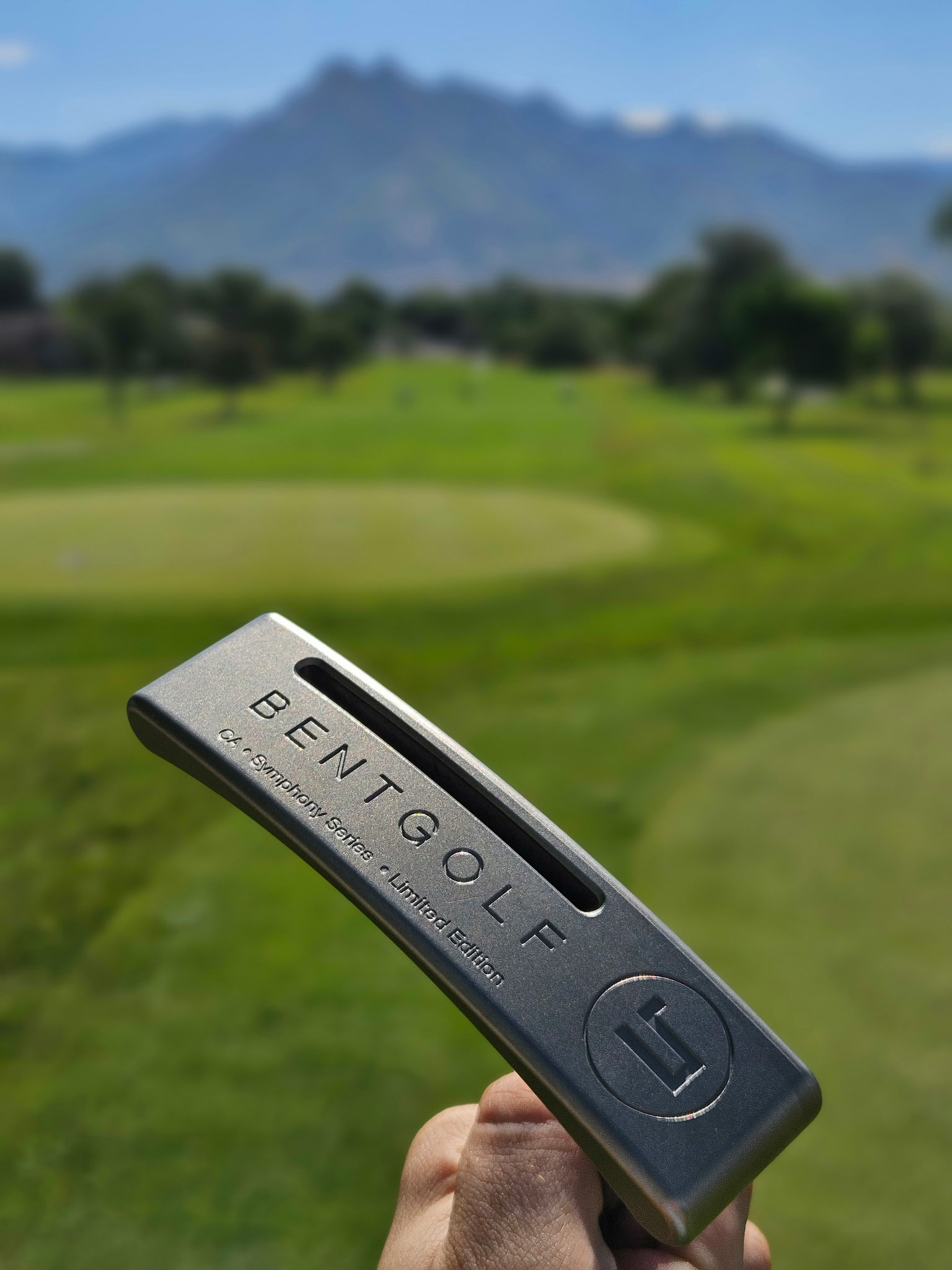 Bent Golf Founder Edition putter against a mountain course backdrop